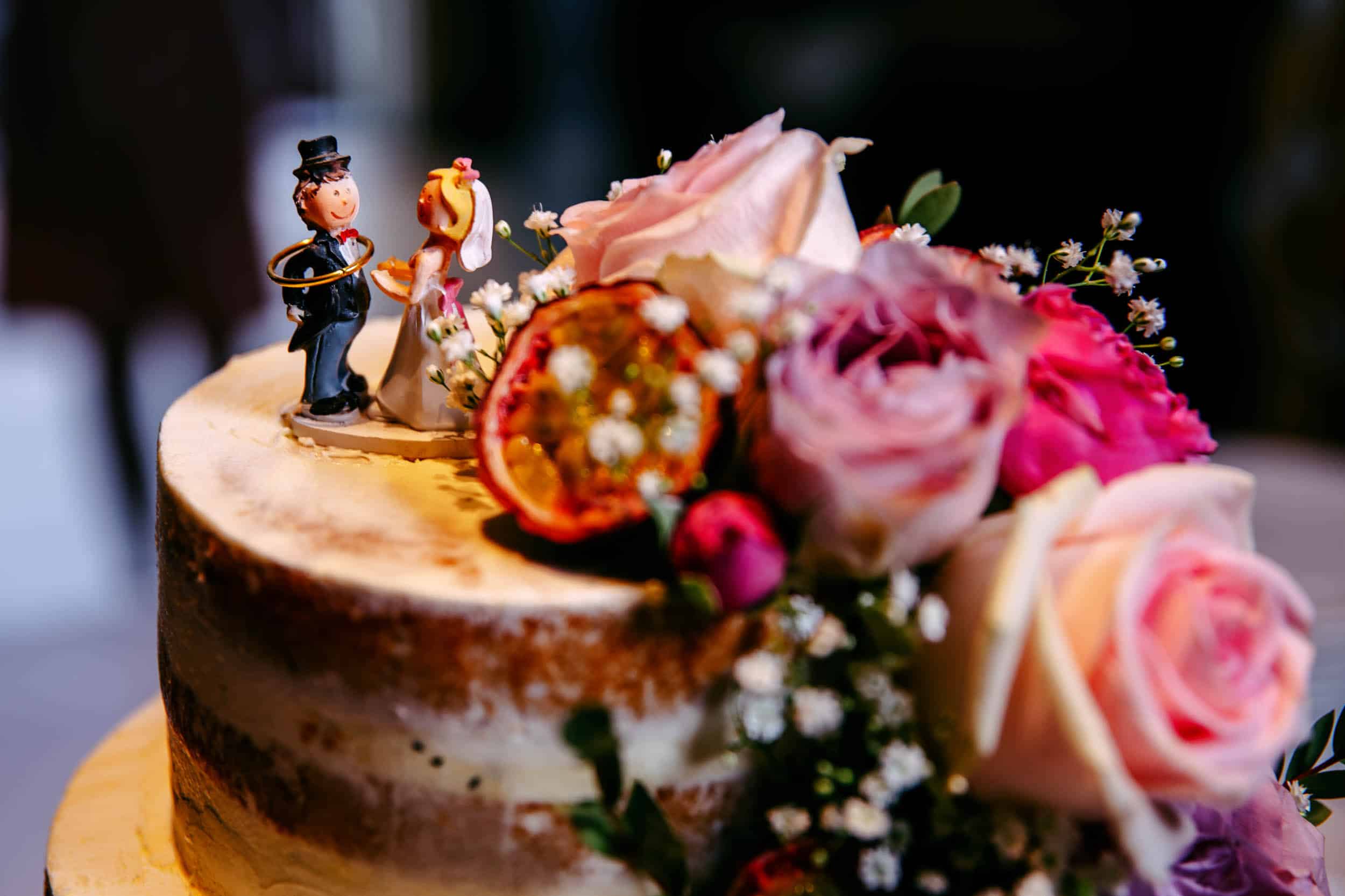 A wedding cake with a figurine on top.