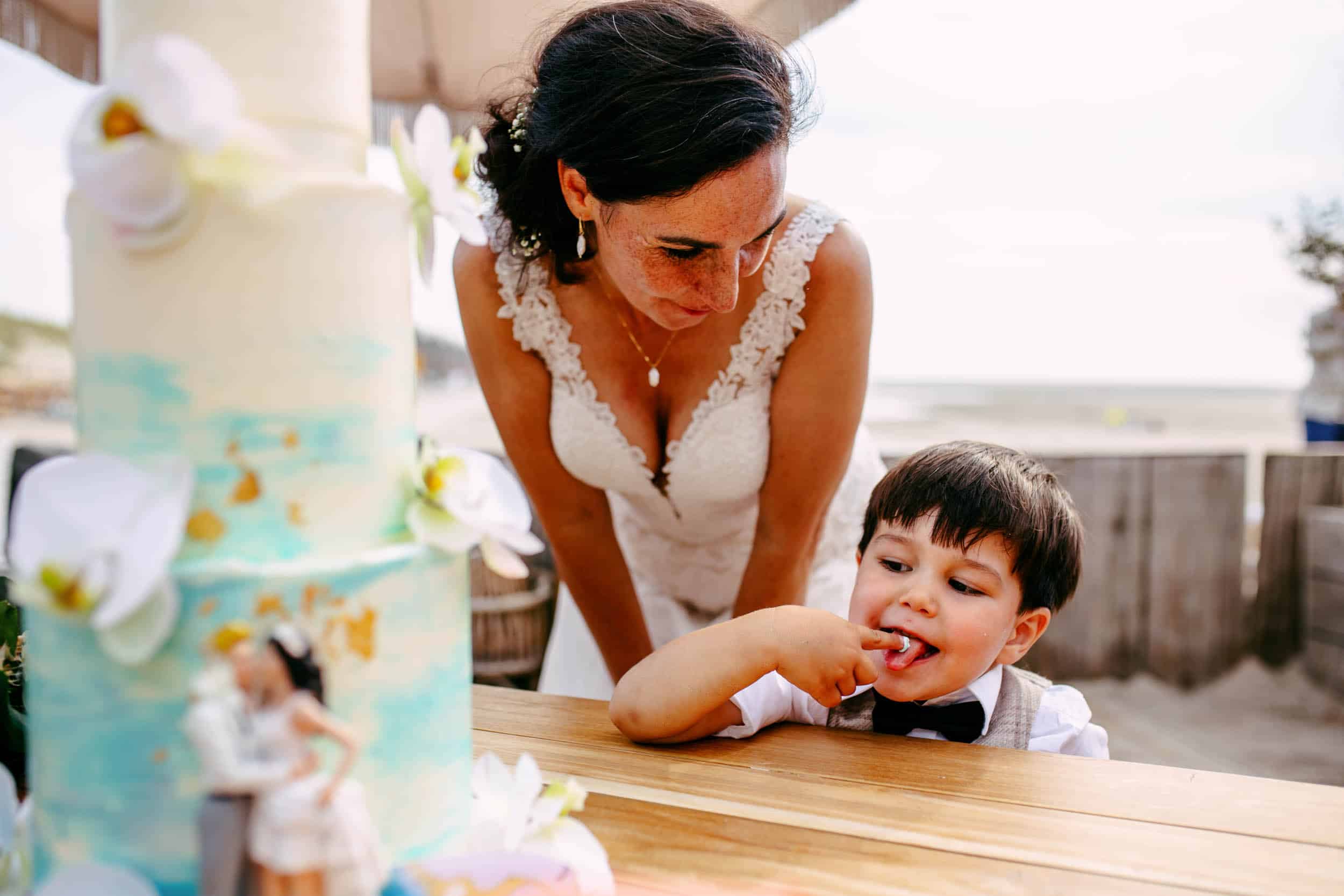 A woman and a little boy look at a cake.