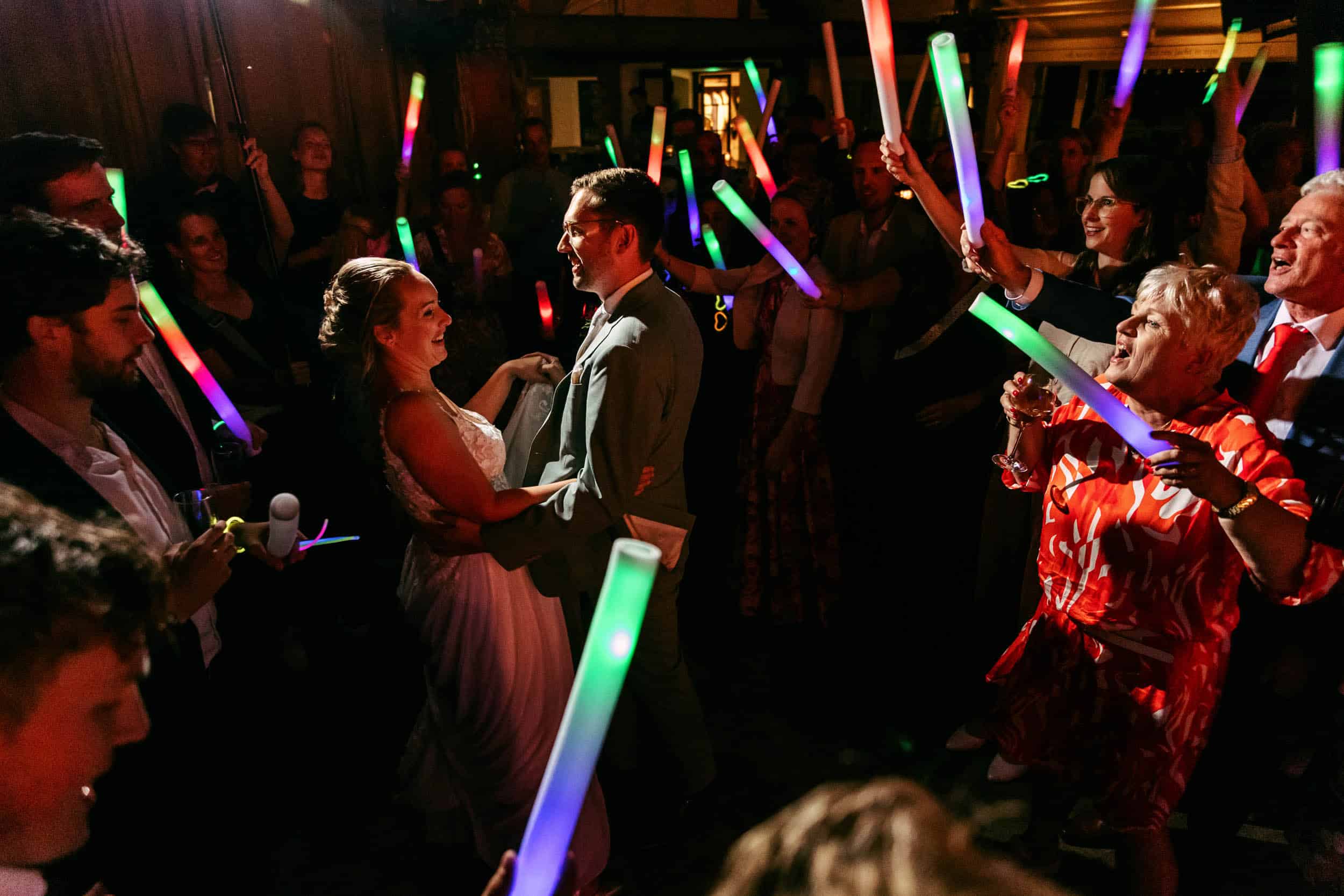 Een bruid en bruidegom dansen met lichtzwaarden op hun bruiloft.